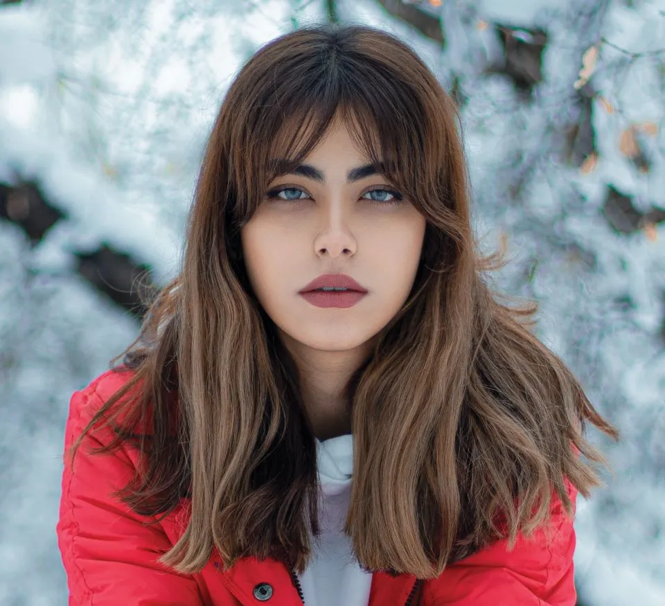 Frau in roter Jacke mit Curtain Bangs
